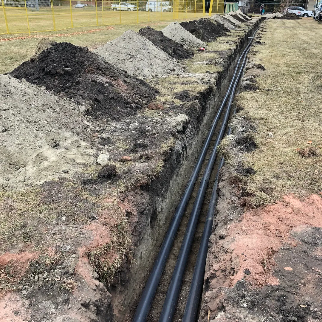 Underground electrical service conduits laid in an open trench